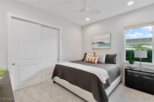 bedroom with ceiling fan, a closet, recessed lighting, and light colored carpet