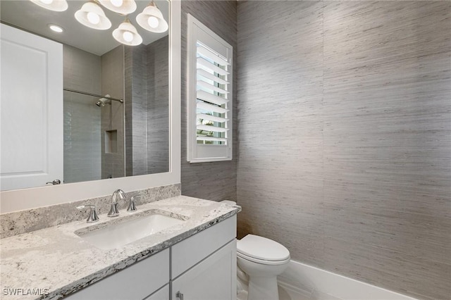 bathroom with vanity, toilet, and walk in shower