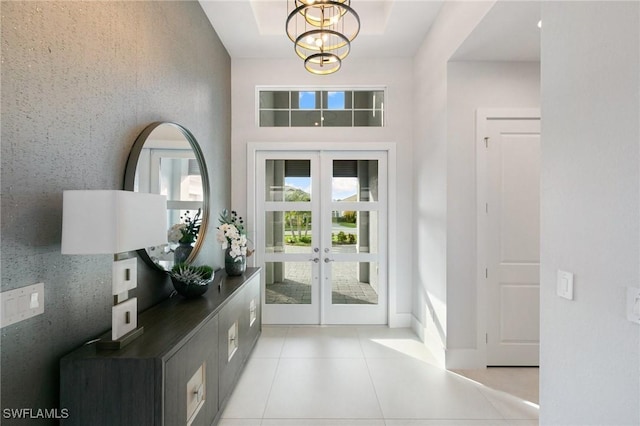 doorway to outside featuring light tile patterned flooring and french doors