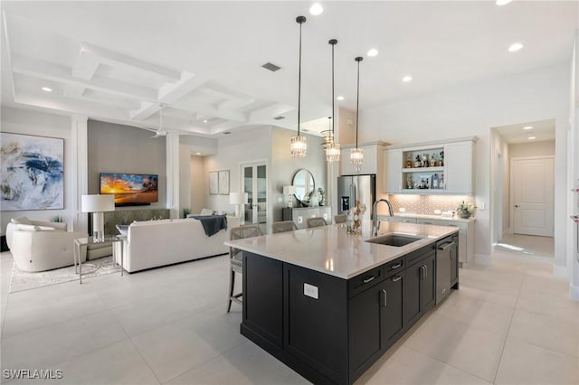 kitchen featuring open shelves, stainless steel appliances, visible vents, a sink, and dark cabinets