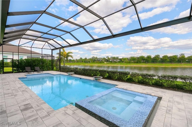 view of pool with a patio area, glass enclosure, a water view, and a pool with connected hot tub