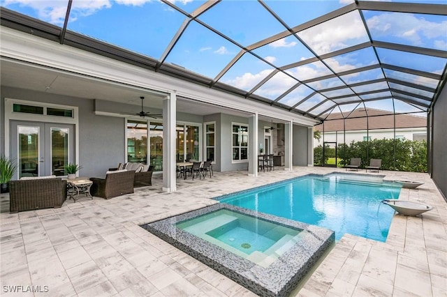 view of pool featuring a patio, ceiling fan, an outdoor hangout area, french doors, and a pool with connected hot tub