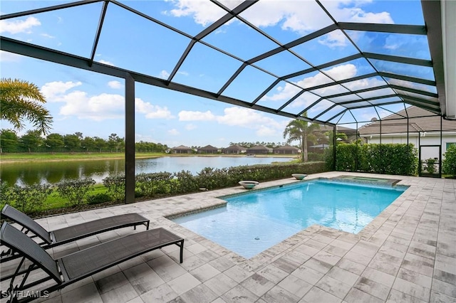 outdoor pool with a patio, a water view, and glass enclosure