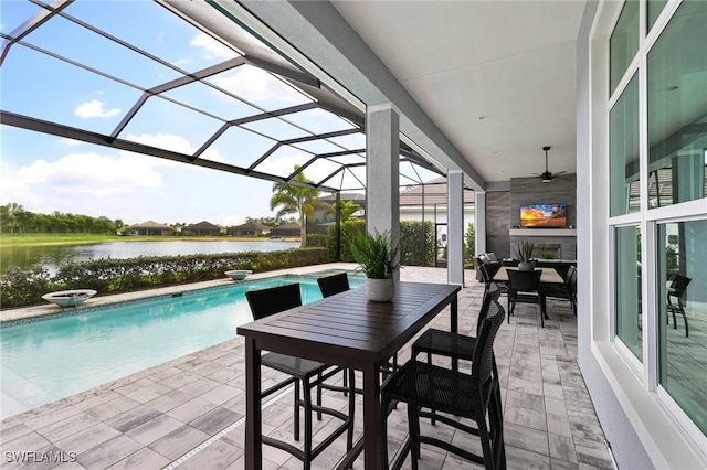 pool featuring outdoor dining space, a lanai, a patio, and ceiling fan