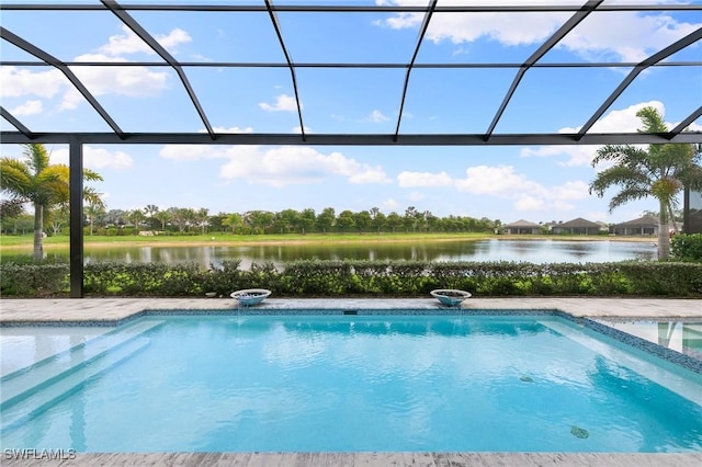 pool featuring glass enclosure and a water view