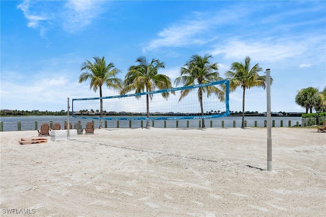 view of home's community with volleyball court and a water view