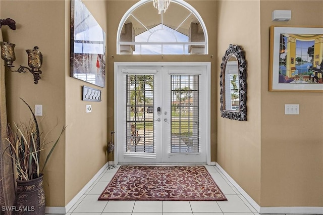 interior space with tile patterned flooring, french doors, and baseboards