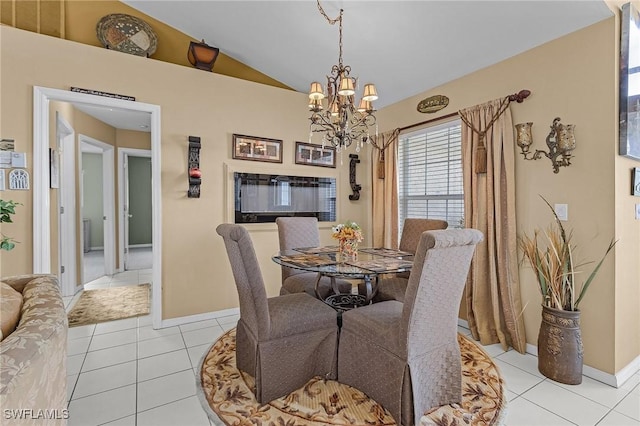 dining space featuring lofted ceiling, light tile patterned flooring, baseboards, and an inviting chandelier