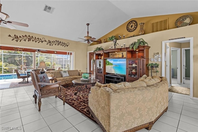 living room featuring a ceiling fan, lofted ceiling, visible vents, and light tile patterned floors