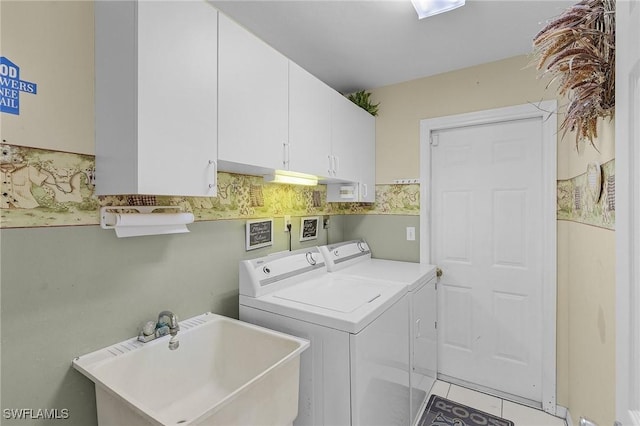 laundry room featuring cabinet space, separate washer and dryer, a sink, and light tile patterned flooring