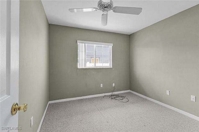 empty room with a ceiling fan and baseboards