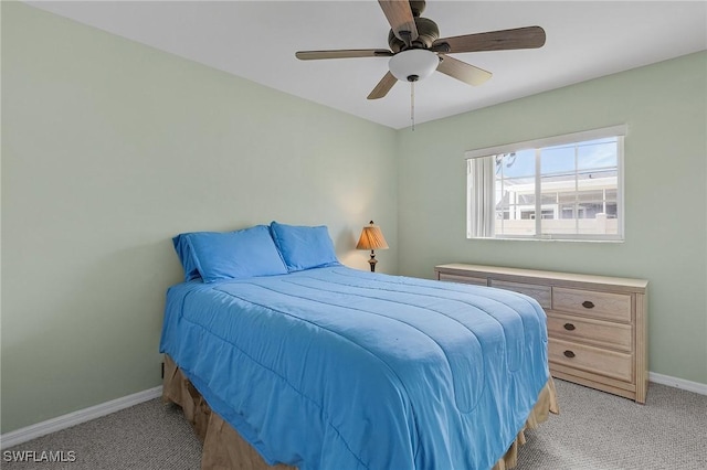 bedroom featuring a ceiling fan, light colored carpet, and baseboards