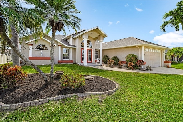 view of front of house featuring a garage, a front yard, concrete driveway, and stucco siding