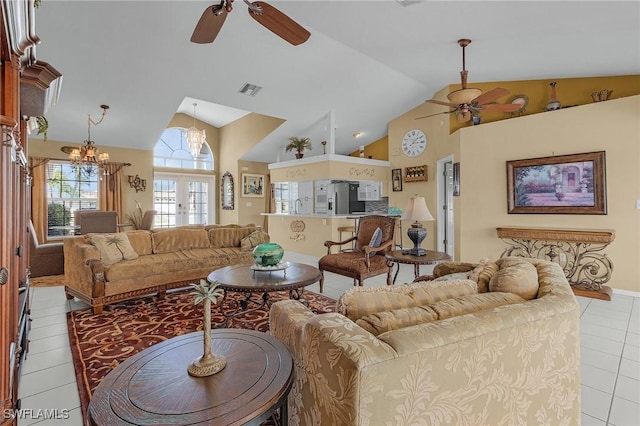 tiled living room with french doors, visible vents, a sink, high vaulted ceiling, and ceiling fan with notable chandelier