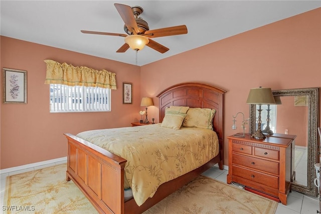 bedroom with light tile patterned floors, baseboards, and a ceiling fan