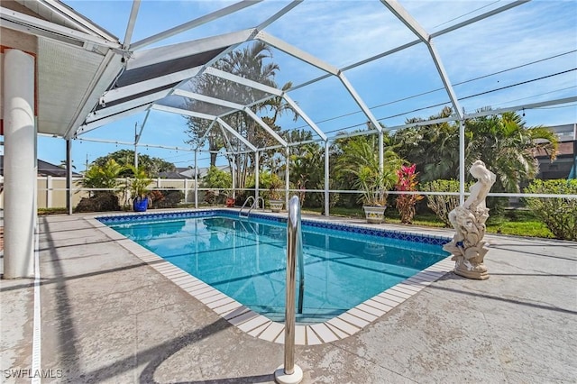 pool with glass enclosure and a patio