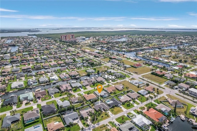 birds eye view of property featuring a water view and a residential view