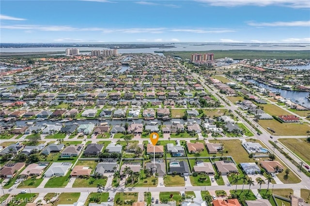 bird's eye view featuring a water view and a residential view