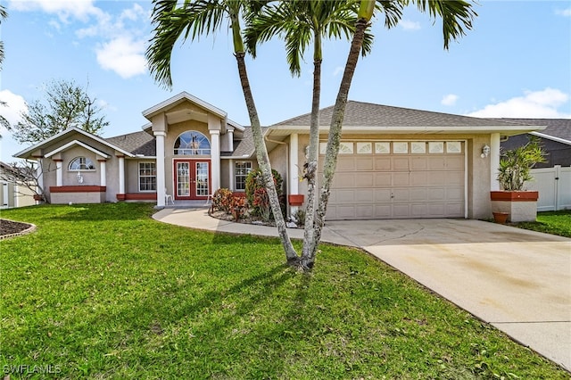 view of front of property with a garage, fence, french doors, stucco siding, and a front yard