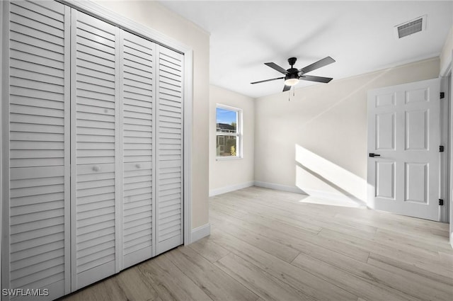 corridor with visible vents, baseboards, and wood finished floors