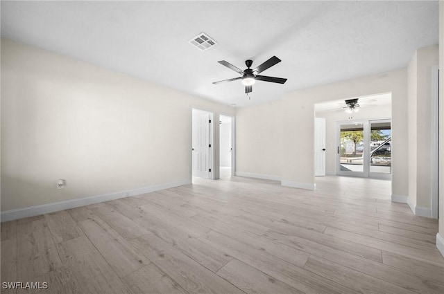 unfurnished room featuring baseboards, a ceiling fan, visible vents, and light wood-style floors