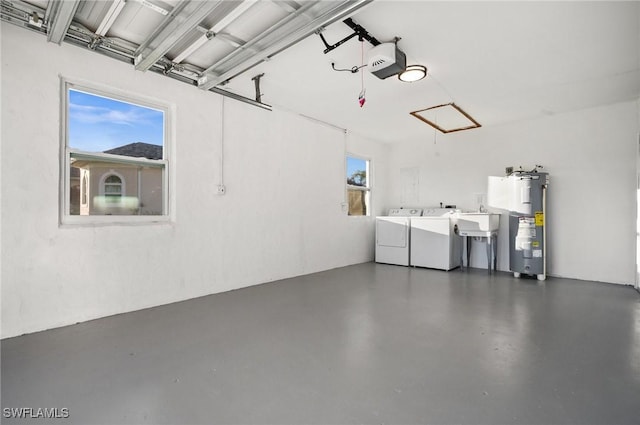 garage featuring a garage door opener, water heater, a sink, and washing machine and clothes dryer