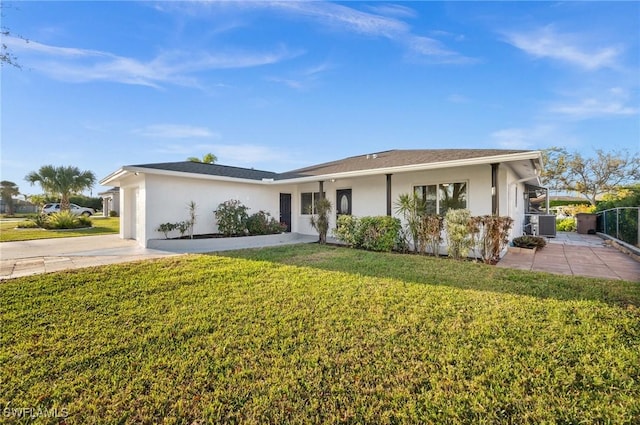 ranch-style home featuring central AC unit, a front yard, and stucco siding