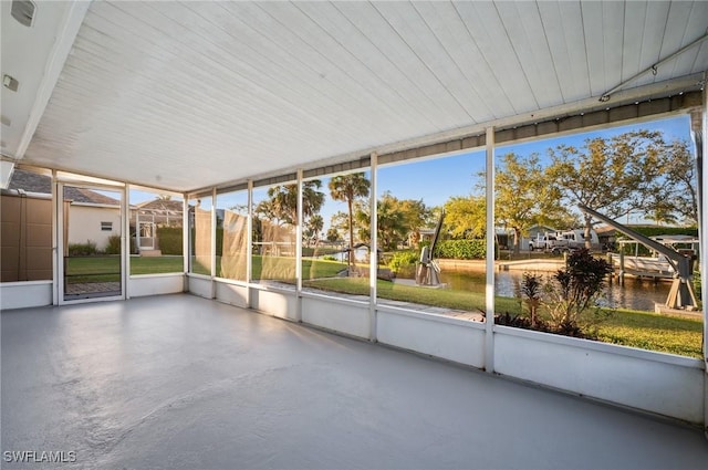 unfurnished sunroom with a water view