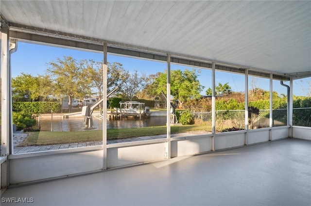 unfurnished sunroom with a water view