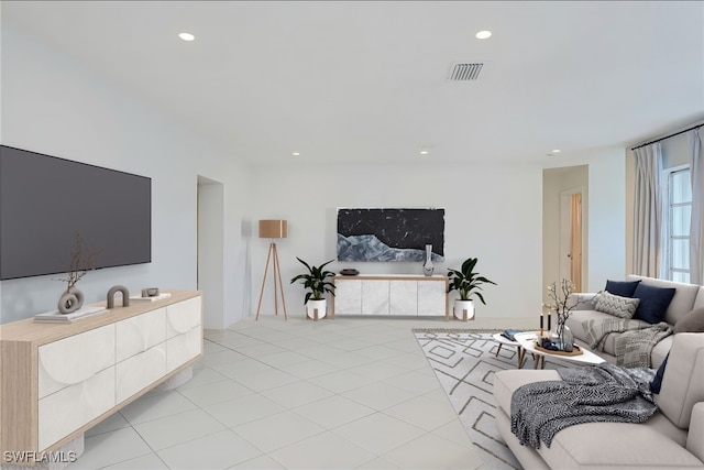 living area featuring light tile patterned floors, visible vents, and recessed lighting