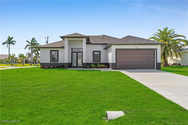 prairie-style house with a shingled roof, concrete driveway, a front yard, stucco siding, and a garage