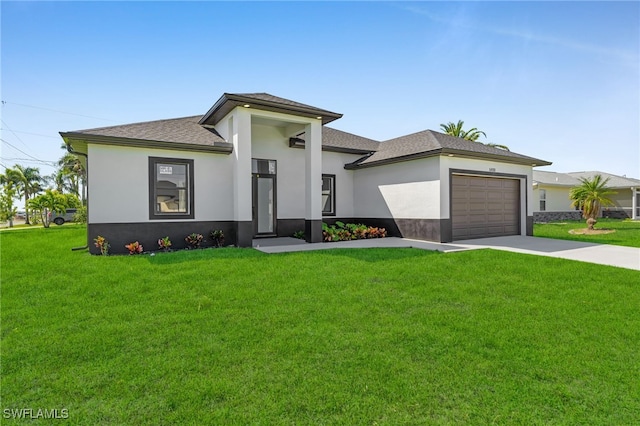 prairie-style house with stucco siding, driveway, a front yard, a shingled roof, and a garage