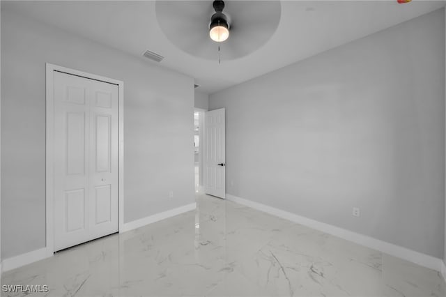 unfurnished bedroom with visible vents, marble finish floor, baseboards, and ceiling fan