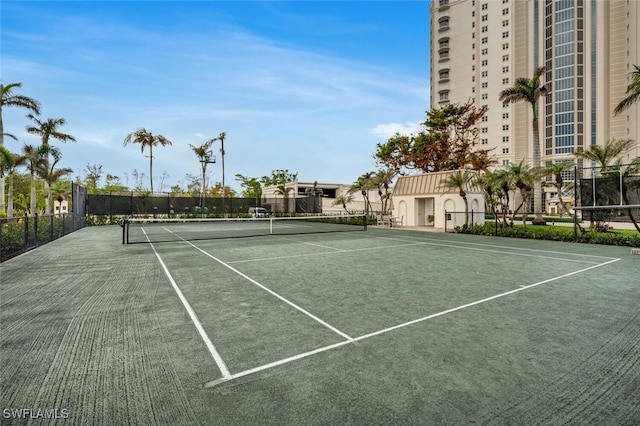 view of tennis court featuring fence