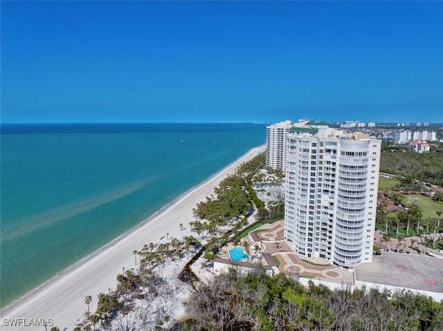 drone / aerial view featuring a water view and a view of the beach