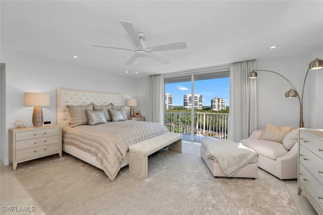 bedroom featuring ceiling fan, recessed lighting, a view of city, and access to exterior