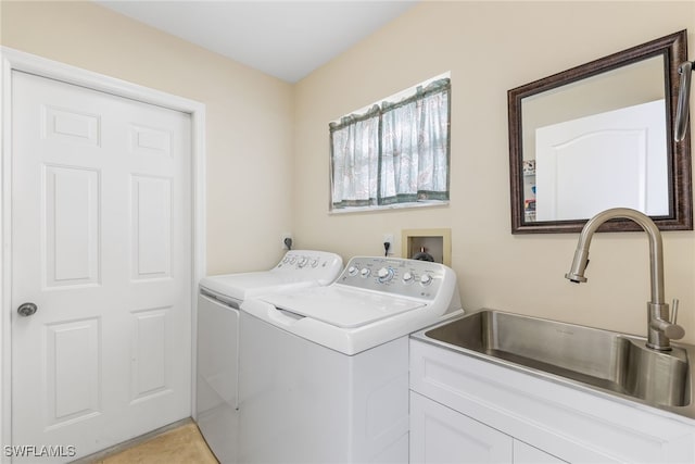 washroom with laundry area, a sink, and washer and clothes dryer