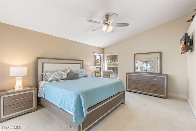 bedroom featuring lofted ceiling, light colored carpet, ceiling fan, and baseboards