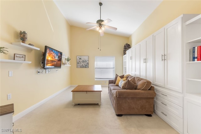 living area featuring lofted ceiling, light carpet, ceiling fan, and baseboards