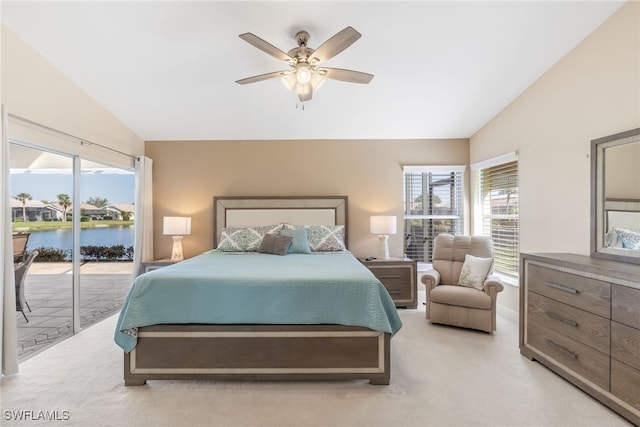 bedroom featuring access to exterior, light colored carpet, vaulted ceiling, and multiple windows