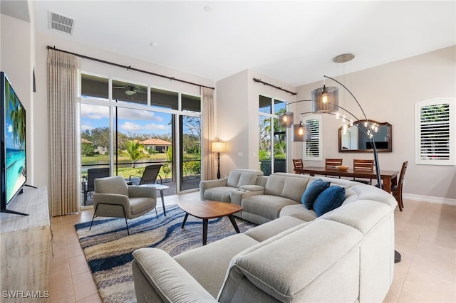 living area featuring a healthy amount of sunlight, visible vents, and light tile patterned flooring