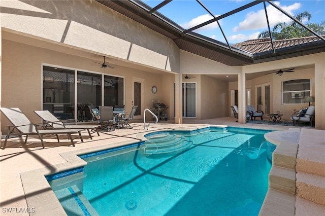 rear view of property with ceiling fan, an outdoor pool, a patio, and stucco siding