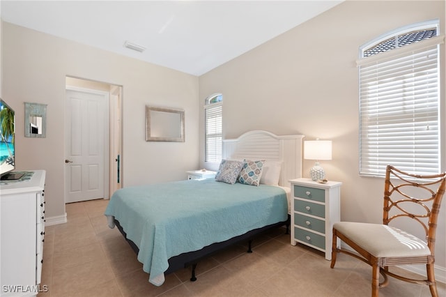 bedroom with visible vents, baseboards, and light tile patterned flooring