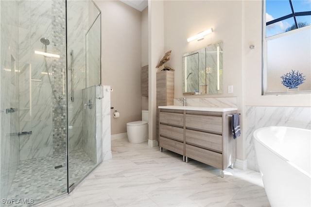 full bathroom with toilet, vanity, a freestanding bath, marble finish floor, and a marble finish shower