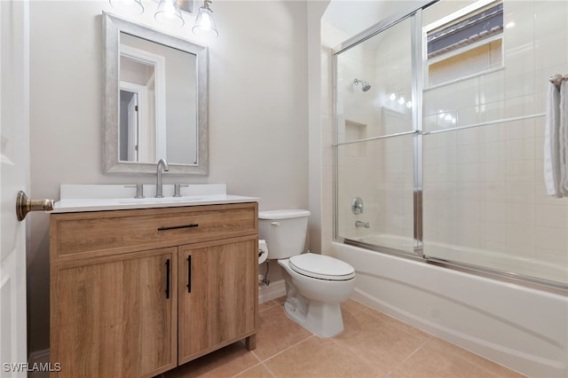 full bath with toilet, vanity, enclosed tub / shower combo, and tile patterned floors