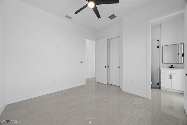 611 NW 25th Ter, Cape Coral, FL 33993 - unfurnished bedroom with light marble finish floors and ceiling fan
