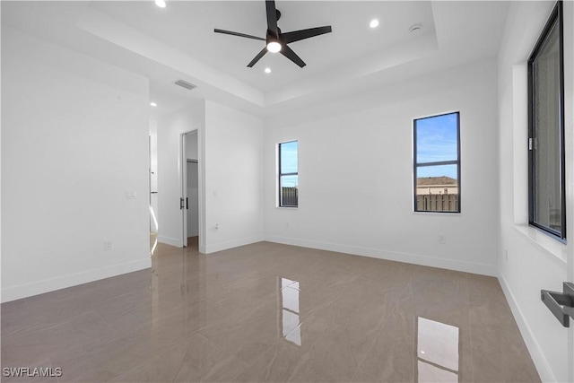 611 NW 25th Ter, Cape Coral, FL 33993 - empty room featuring a tray ceiling, healthy amount of natural light, recessed lighting, and ceiling fan
