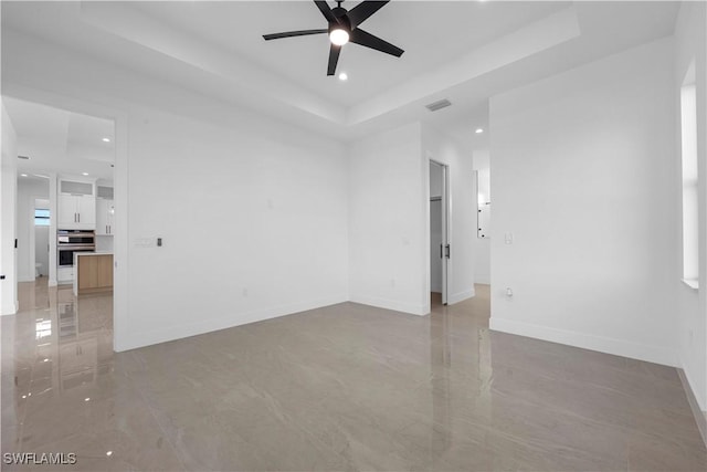 611 NW 25th Ter, Cape Coral, FL 33993 - spare room with a ceiling fan, a raised ceiling, and recessed lighting