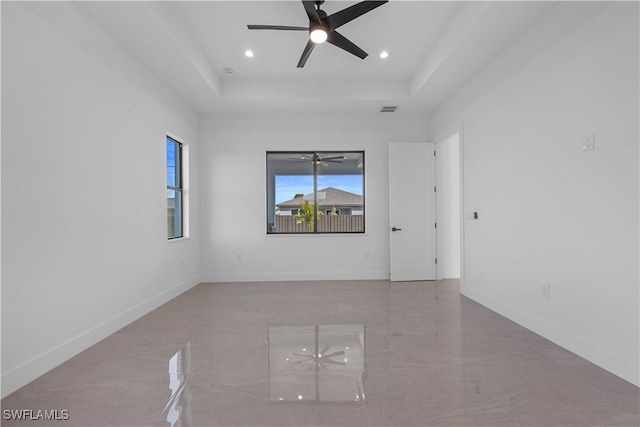 611 NW 25th Ter, Cape Coral, FL 33993 - unfurnished room with ceiling fan, a tray ceiling, and recessed lighting