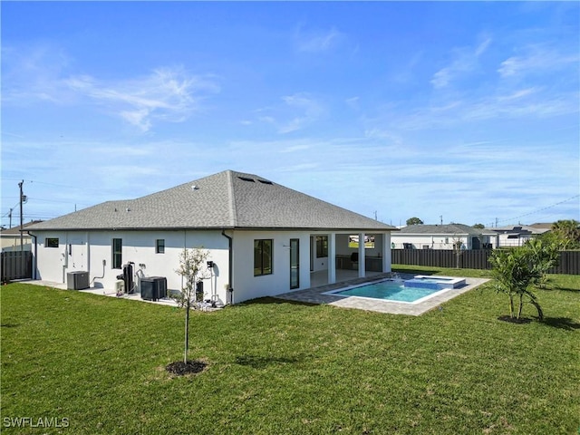 611 NW 25th Ter, Cape Coral, FL 33993 - back of house featuring a fenced backyard, stucco siding, a shingled roof, and a pool with connected hot tub